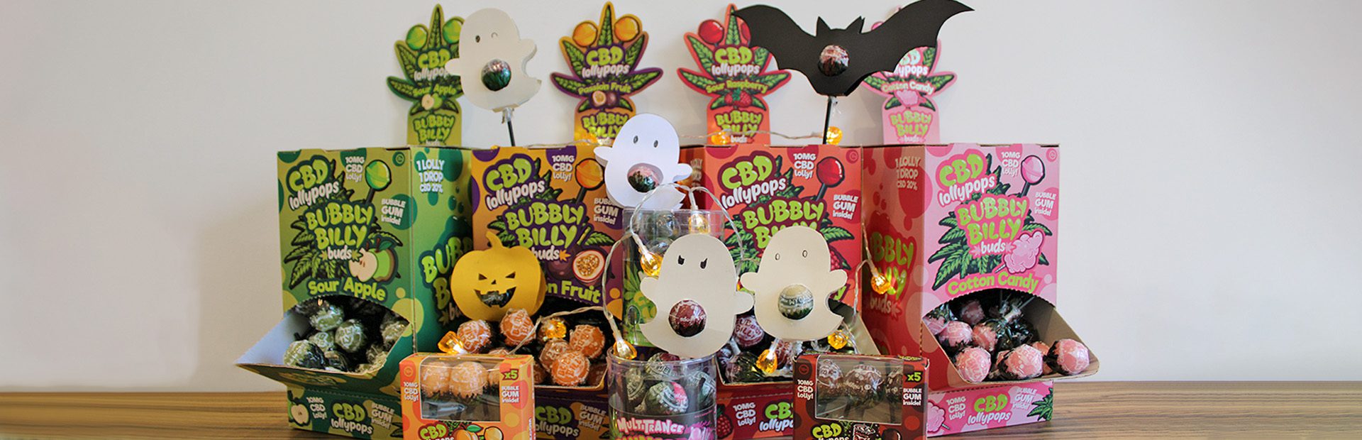 Colorful Halloween-themed cannabis shop display with decorated lollipops and pumpkins — inspiration on how to decorate your cannabis store for Halloween.