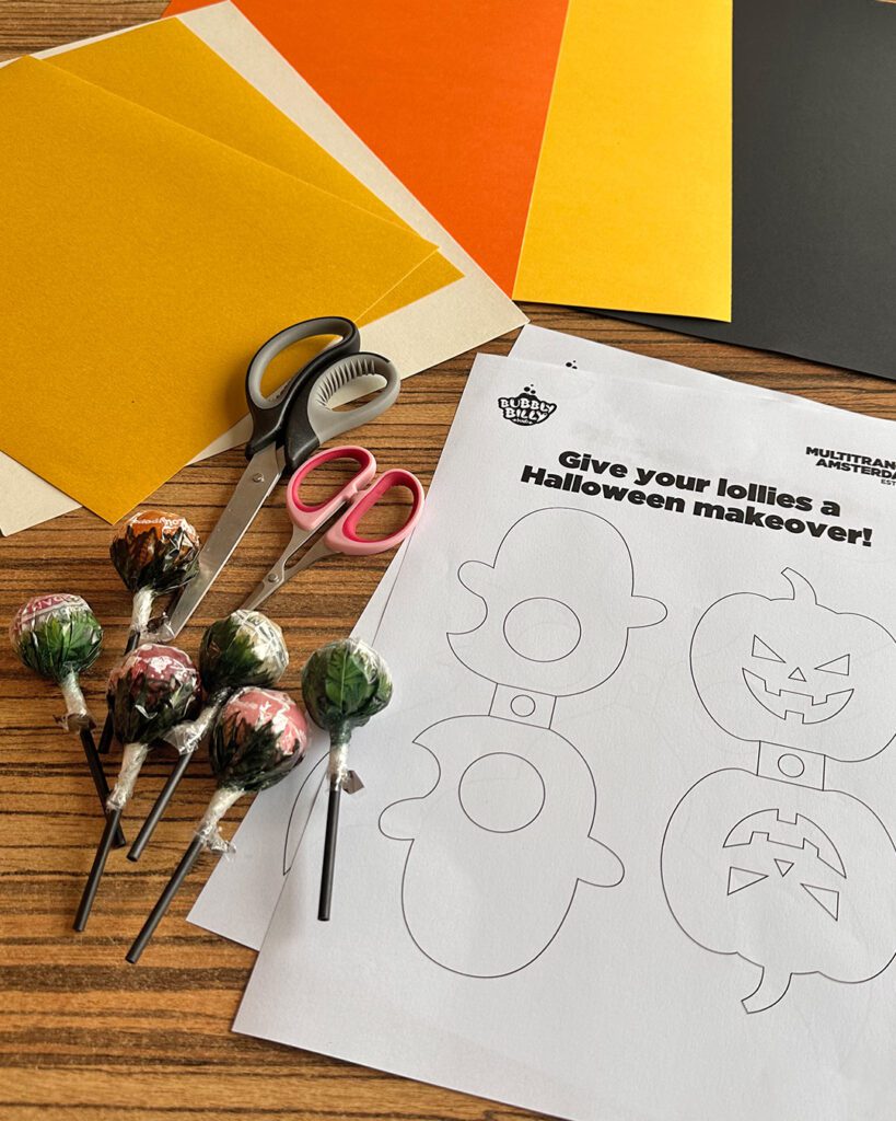 Printable Halloween lollipop holder templates with scissors and paper — a creative way to decorate your store for Halloween.