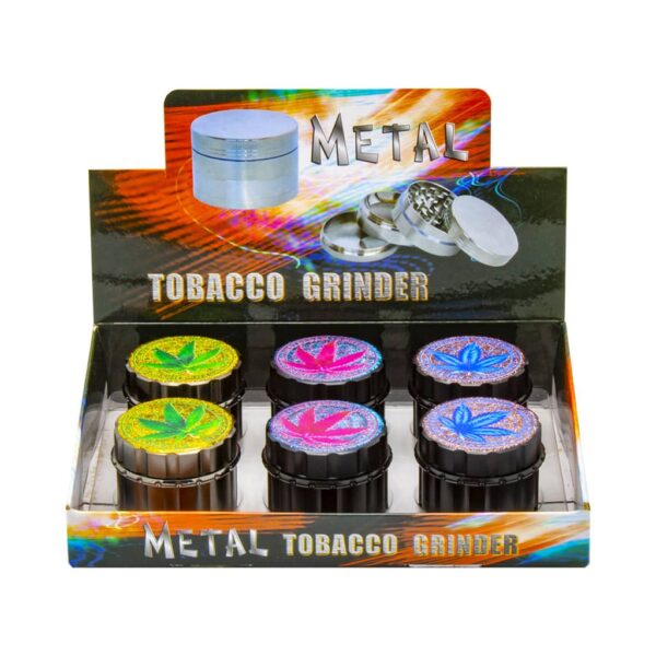 Display of 6 black metal 4-part herb grinders with glitter cannabis leaf designs, wholesale packaging