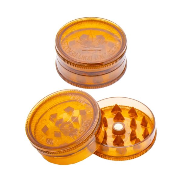 Copper-colored plastic herb grinder with shark teeth and magnetic lid, cannabis leaf design, shown open and closed