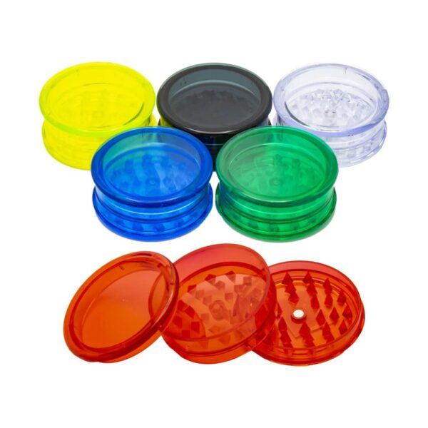 Close-up of colorful plastic herb grinders with stash storage, 2-part magnetic design, shark teeth, and cannabis leaf lids