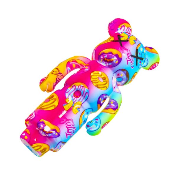 Back view of a multicolor silicone bear-shaped pipe with playful donut print