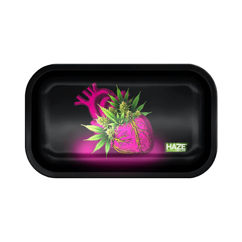 Large rolling tray with a glowing pink anatomical heart intertwined with green cannabis leaves.