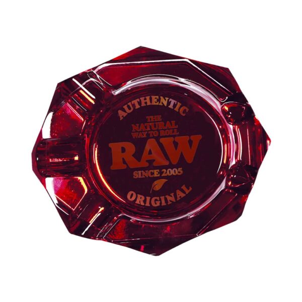 RAW ruby red thick glass ashtray with embossed logo on white background